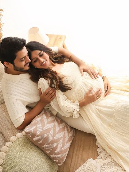 A relaxed and cozy portrait of the couple lying down amidst soft pillows and blankets in our boho studio. This angle offers a unique and intimate perspective on their connection.