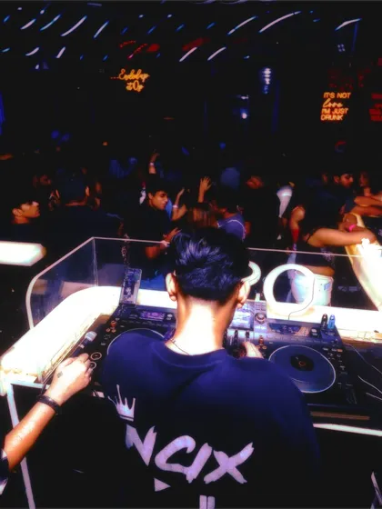A view from behind the console, showing a packed dance floor. My focus is always on reading the room and playing the right tracks to keep the party going.