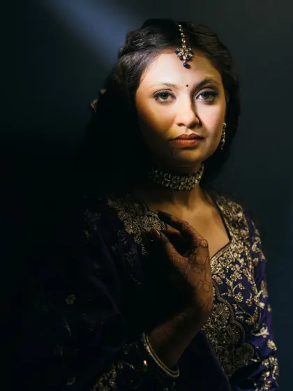 An artistic, moody shot of the sangeet look, playing with light and shadow.