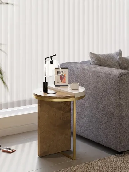 The split-top side table shown in a living room setting, perfectly positioned to hold a lamp and a cup of coffee.