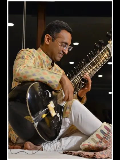 Seated comfortably for a relaxed and soulful performance. The informal setting of a house concert allows for a different kind of musical exploration.