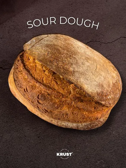 A close-up of my artisan sourdough loaf, showcasing its beautiful, rustic crust achieved through slow fermentation. This is the foundation of a great sandwich and a testament to my passion for traditional baking.