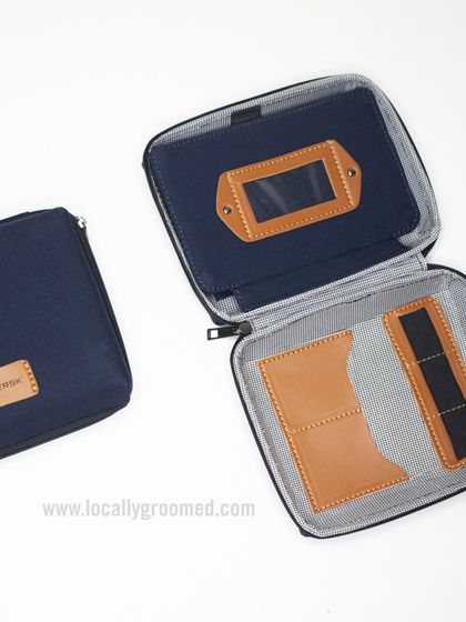 This tech pouch for Maersk features a stylish navy fabric with leather accents and a clear ID window, combining functionality with a premium feel.