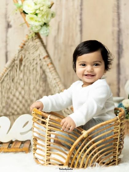 A bright and happy portrait of a baby boy celebrating his first birthday in our studio.