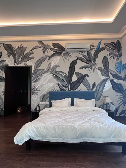 Black and white can be just as lush. This monochrome tropical mural brings a sophisticated and modern jungle vibe to a bedroom, proving that bold patterns can also be serene.