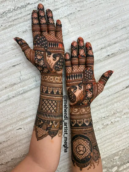 An engagement mehendi that tells a story of love. I incorporated the couple's initials and elegant peacock motifs to create a design that is both personal and timeless.