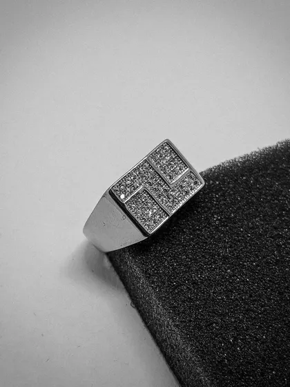 A modern take on the classic men's ring. This sterling silver signet ring features a bold, rectangular face with a geometric pattern paved with high-grade CZ stones, offering a sharp and contemporary look.