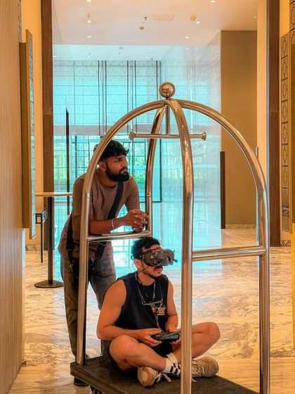 A candid shot of me getting a "dolly" shot by sitting on a luggage cart. This is an example of the creative, weird, and fun solutions we find on set.