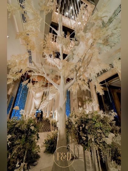 The centerpiece of a winter wonderland theme: a magnificent, life-sized white tree. This stunning installation creates a focal point and sets a magical, frosty tone for the entire event space.