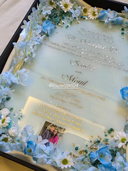 Another angle of the blue resin wedding invitation, highlighting the beautiful floral arrangement inside the presentation box.