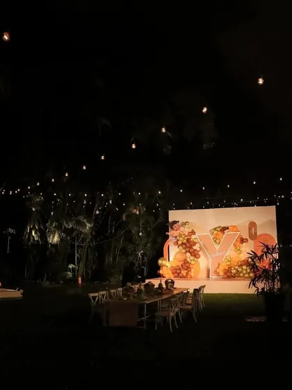 A wide view of the magical evening we created for Yatharv Yash's 4th birthday. The entire outdoor space at the Taj West End was transformed with warm string lighting, a custom "Y" initial backdrop, and fun activity stations for the children. Note: Media 15 is a duplicate of this image.