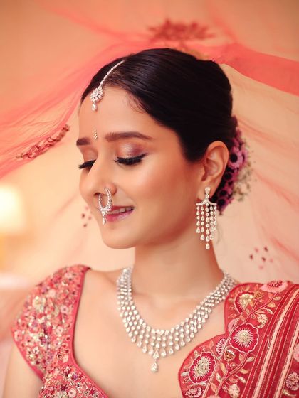 A close-up of the finished bridal glam, showing the soft, shimmery eyeshadow and flawless skin. The bride looks serene and beautiful.