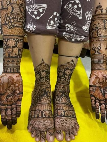 A complete bridal package with stunning mehndi on both hands and feet. The design features couple portraits and a baraat scene for a truly grand look.