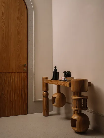 This corner showcases our 'Dash and Dot' console table. Made from solid ash wood, its form is inspired by turned-wood toys, with spherical and cylindrical legs that give it a playful, floating appearance.
