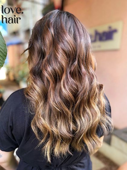 Another angle of the 'sun-kissed' balayage, showing the beautiful blend of highlights and lowlights from the back.