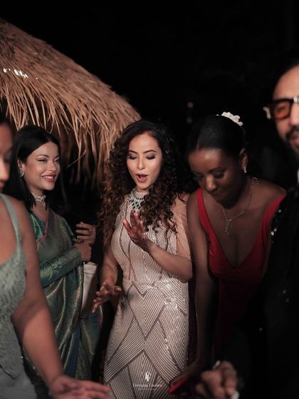The bride dancing with her friends and family at the reception, a candid moment full of life and happiness.