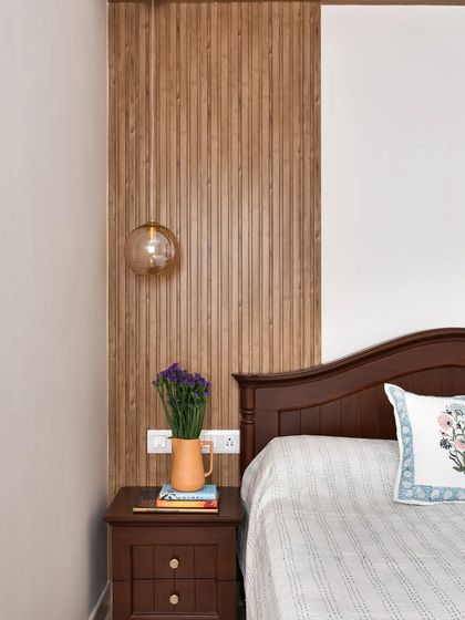 Another view of the guest room, showing how the vertical rafters add texture and height to the wall behind the bed.