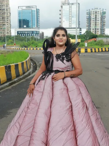 This unique gown is complemented by a makeup look that is both creative and beautiful, a testament to our student's growing artistry.