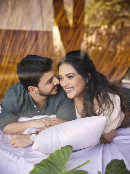Laughter and love in a rustic cabin setting. This candid photo captures the couple's genuine connection. The styling was kept simple and natural to match the cozy, outdoor vibe of their pre-wedding shoot.