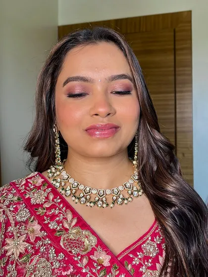 A close-up of the eye makeup. The soft blend of pink and brown tones creates a romantic feel that enhances her eyes without overpowering them.