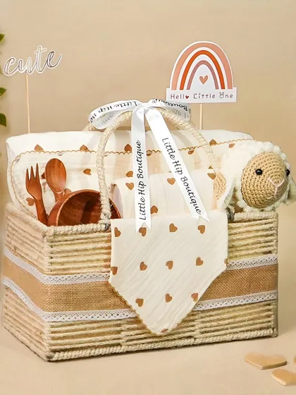 A heart-themed baby hamper with a cute sheep rattle and wooden utensils. The natural textures and neutral colors give it an organic, eco-friendly feel.