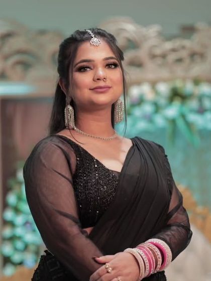 A happy and confident reception portrait. The soft glam makeup with a hint of shimmer on the eyes perfectly suits the celebratory mood.