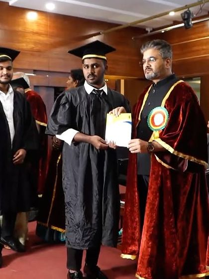 Presenting a graduation certificate to a student. Each certificate represents years of hard work, dedication, and the promise of a bright future.