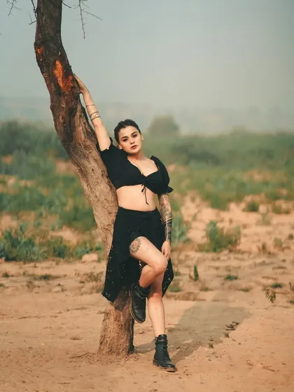 An outlaw in the wilderness. The desolate landscape, the edgy all-black outfit, and the strong pose come together to create a story of defiance and strength.