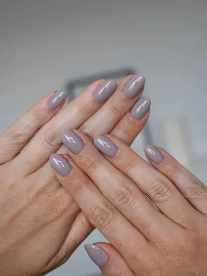 A beautiful mauve-toned neutral polish on almond-shaped nails. It's a sophisticated, "my nails but better" shade that's perfect for everyday wear.