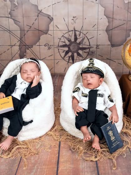 Two little travelers, ready to see the world. This themed setup for newborn twins is double the fun, featuring one as a pilot and the other as a stylish globetrotter.