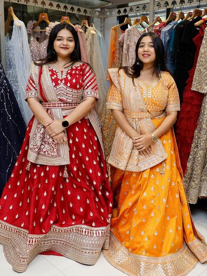 A full-length view of the red and yellow lehengas, showcasing their vibrant colors and beautiful designs.