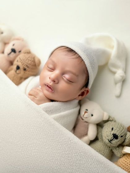 Tucked in with his teddy bear friends. This angled shot provides a different perspective on this classic and beloved newborn setup.