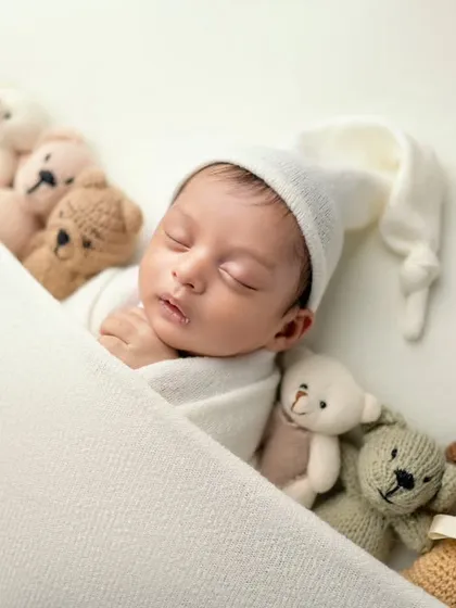 Tucked in with his teddy bear friends. This angled shot provides a different perspective on this classic and beloved newborn setup.