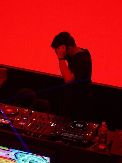 A moment of intense focus at the console at Ginza. Crafting a seamless musical journey requires complete immersion in the sound.