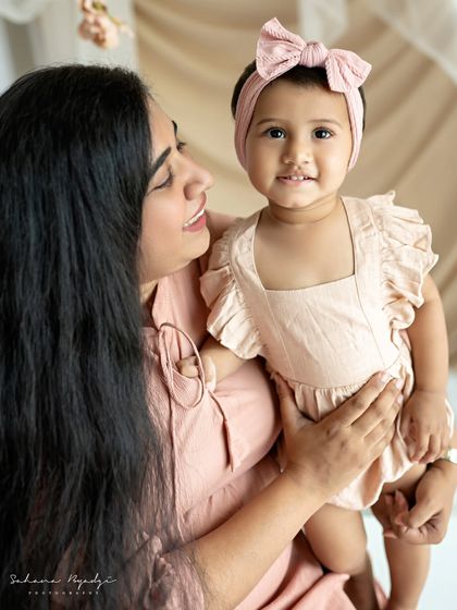 "AMMA". A close-up of a mother and daughter, their faces full of love and happiness.