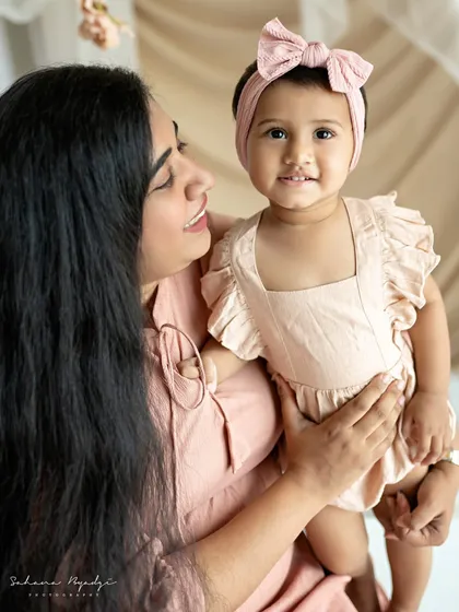 "AMMA". A close-up of a mother and daughter, their faces full of love and happiness.
