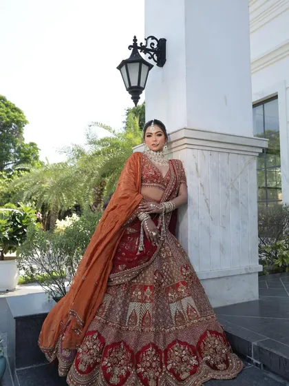 This angle captures the regal posture of the bride and the beautiful fall of the lehenga. The combination of colors and textures makes it a photographer's dream.