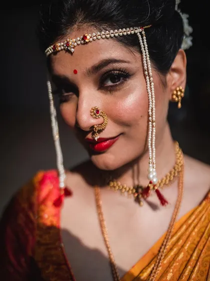 A close-up portrait of a beautiful Maharashtrian bride. I pay close attention to the details of traditional attire, like the intricate nath and mundavalya, ensuring these important cultural elements are captured with elegance.
