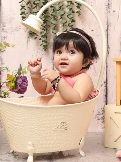 A happy baby enjoying a fun tub time session. This setup is perfect for capturing those adorable expressions and chubby baby features in a playful, water-themed environment.