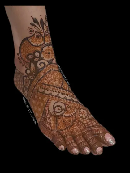 A side view of a foot mehendi design. This shows how the pattern wraps around the foot, creating a beautiful and complete look from every angle.