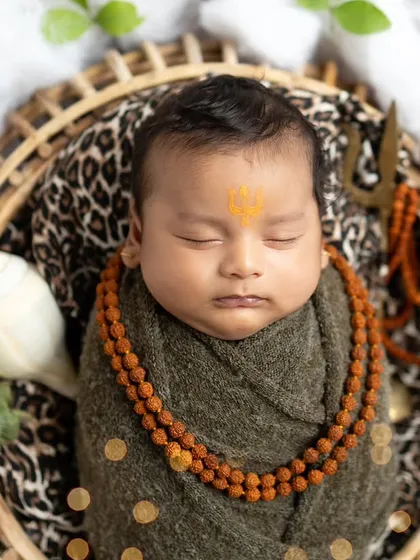 A close-up portrait of our little Mahadev, highlighting the peaceful expression and the tripundra on his forehead.