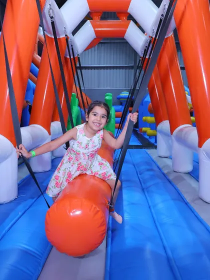 It's not just about jumping, it's about adventure! Our inflatable kingdom includes unique challenges like this swinging obstacle, providing hours of fun for kids of all ages.