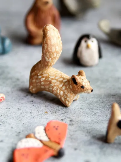 A detailed miniature squirrel with a bushy tail, demonstrating the sculpting techniques taught in our hands on workshop.