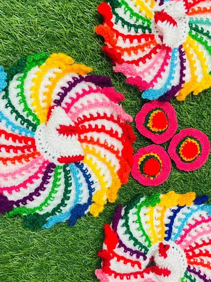 A glimpse of my vibrant rainbow poshak collection. These cheerful, multi-colored dresses are designed to bring extra joy and color to your daily worship. Each one is handmade with soft, colorful yarn.