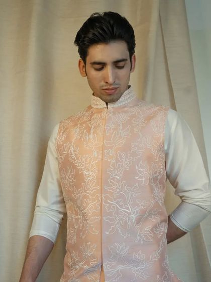This jacket perfectly complements a silk kurta pajama, ensuring you step out in unforgettable style for any festive occasion.