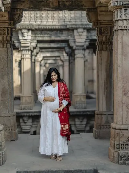 A stunning solo portrait set against the historic architecture of the Adalaj Stepwell. The grandeur of the location adds to the beauty of this moment.