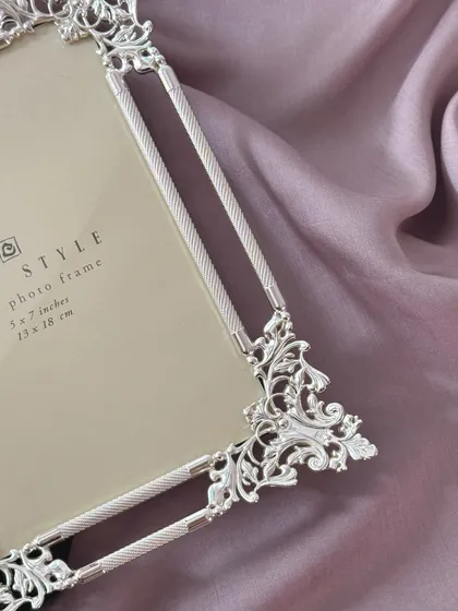 A close-up of the intricate corner detailing on my ornate silver frame. The craftsmanship is designed to make the frame as much of a masterpiece as the picture it holds.