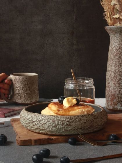 A beautifully styled breakfast scene featuring pieces from 'The Rock Collection,' demonstrating how these bold, sculptural forms can be integrated into daily life.
