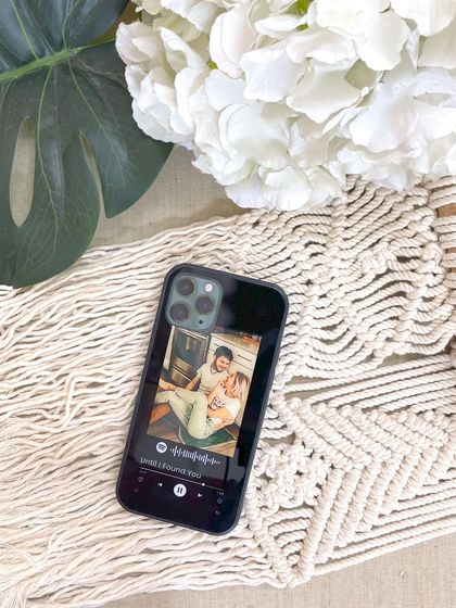 A custom glass phone cover featuring a Spotify song player design and a personal photo. It's a stylish and functional way to carry a memory with you, available for just ₹490.