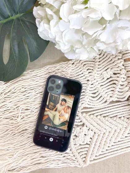 A custom glass phone cover featuring a Spotify song player design and a personal photo. It's a stylish and functional way to carry a memory with you, available for just ₹490.
